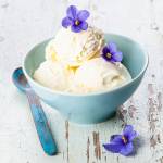 Vanilla ice cream decorated violet flower