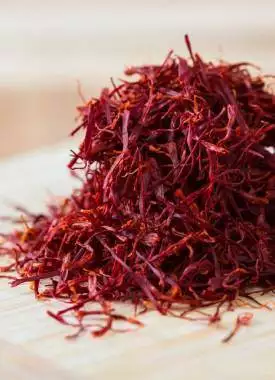 Handful of real saffron on a bamboo board, macro